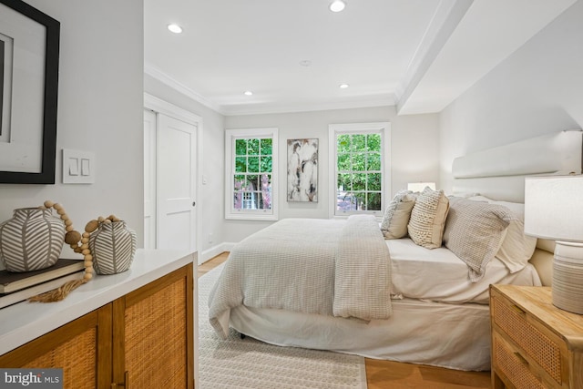 bedroom featuring crown molding and hardwood / wood-style flooring