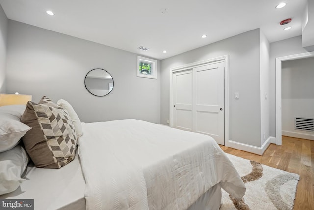 bedroom featuring light hardwood / wood-style flooring and a closet