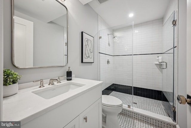 bathroom with walk in shower, vanity, and toilet