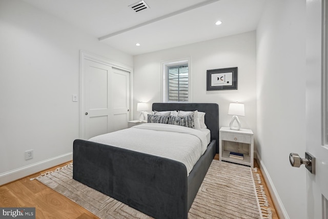 bedroom with a closet and light hardwood / wood-style floors