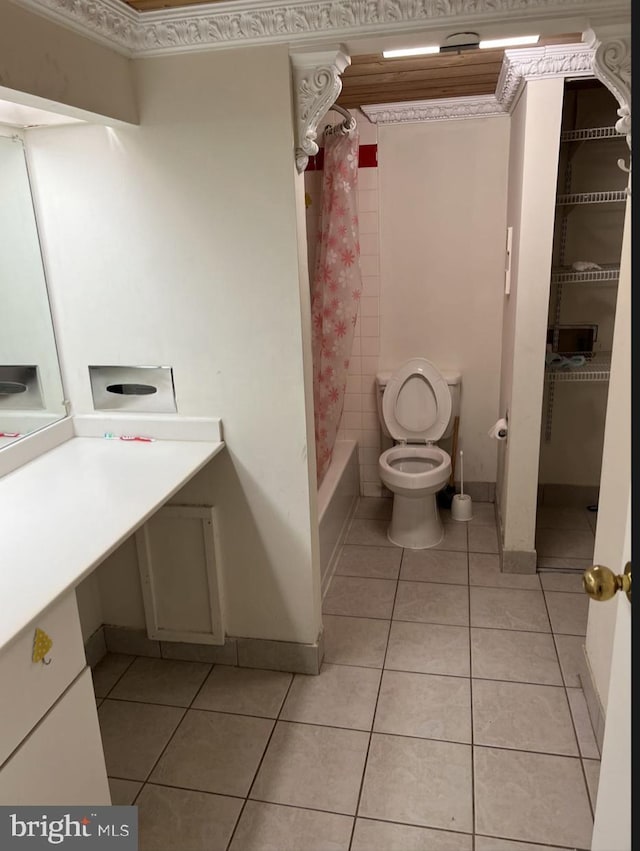 full bathroom with shower / tub combo, tile patterned flooring, vanity, ornamental molding, and toilet