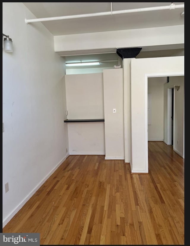 unfurnished room with hardwood / wood-style floors