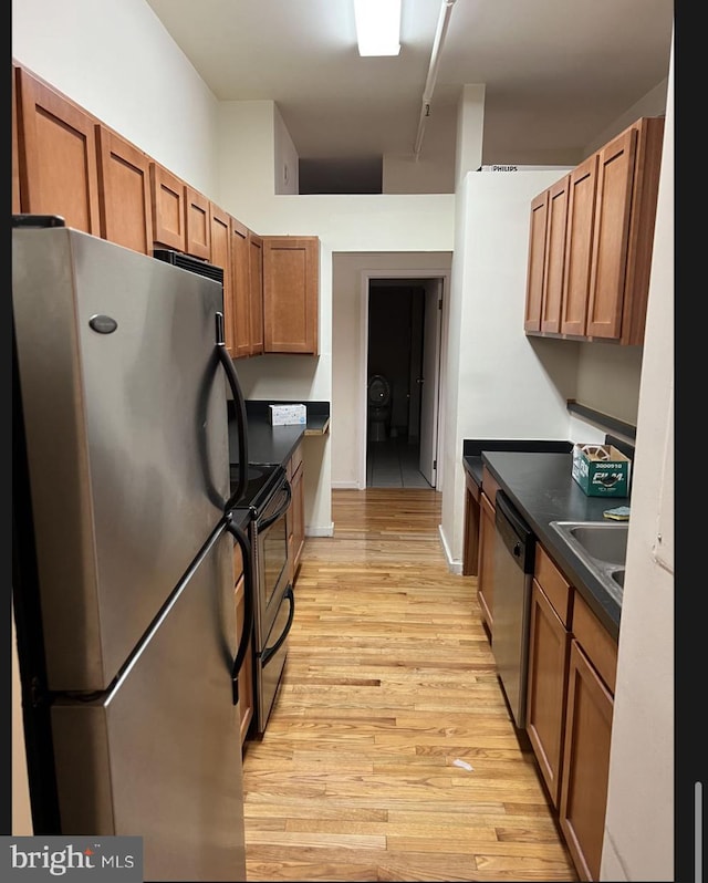 kitchen featuring sink, stainless steel appliances, and light hardwood / wood-style flooring