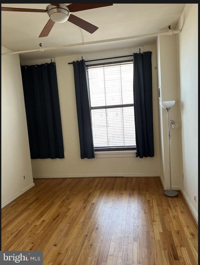 empty room featuring ceiling fan and light wood-type flooring