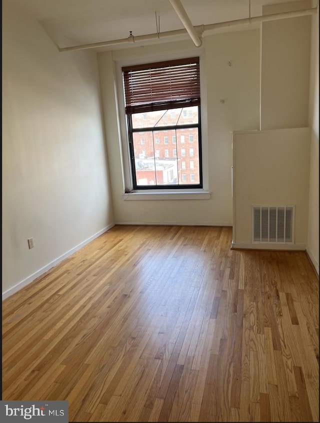 unfurnished room featuring wood-type flooring