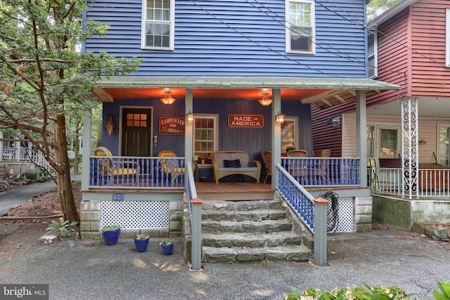 view of exterior entry with covered porch