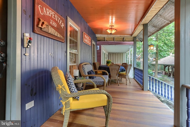 sunroom / solarium featuring wood ceiling