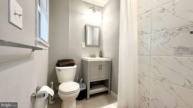 bathroom featuring tile patterned flooring, vanity, and toilet