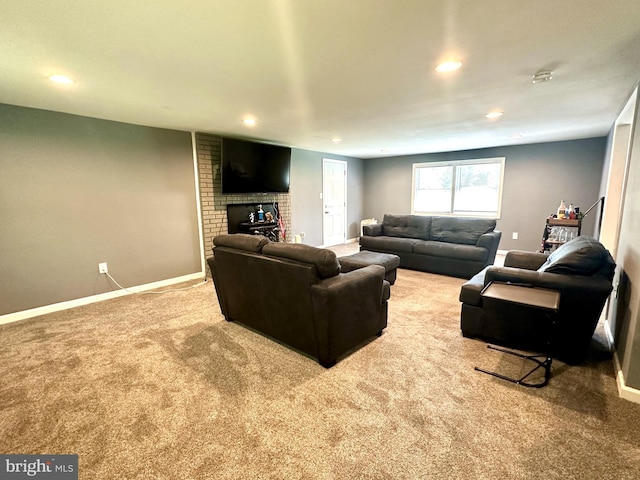 carpeted living room with a fireplace and brick wall