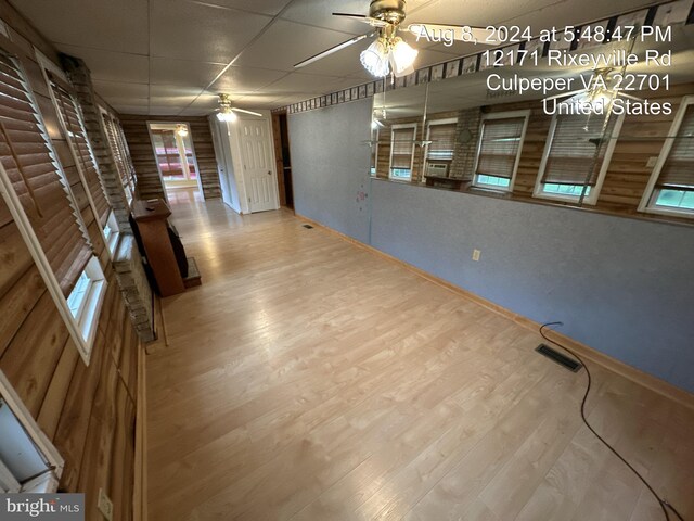 spare room featuring hardwood / wood-style flooring, a paneled ceiling, and ceiling fan