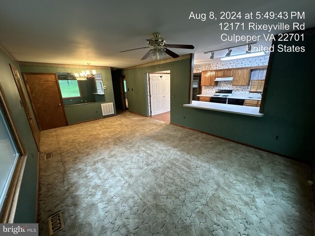 unfurnished room featuring crown molding, vaulted ceiling, and ceiling fan with notable chandelier