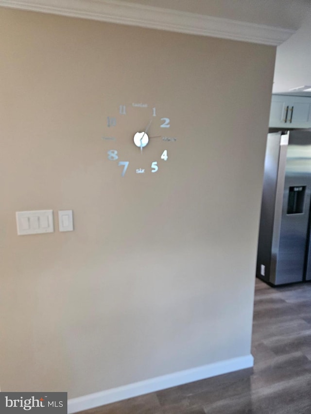 details with stainless steel refrigerator with ice dispenser, crown molding, and hardwood / wood-style floors