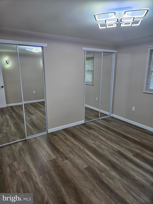 unfurnished bedroom with dark hardwood / wood-style floors