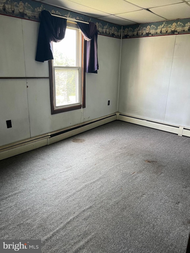 empty room featuring a drop ceiling and carpet flooring