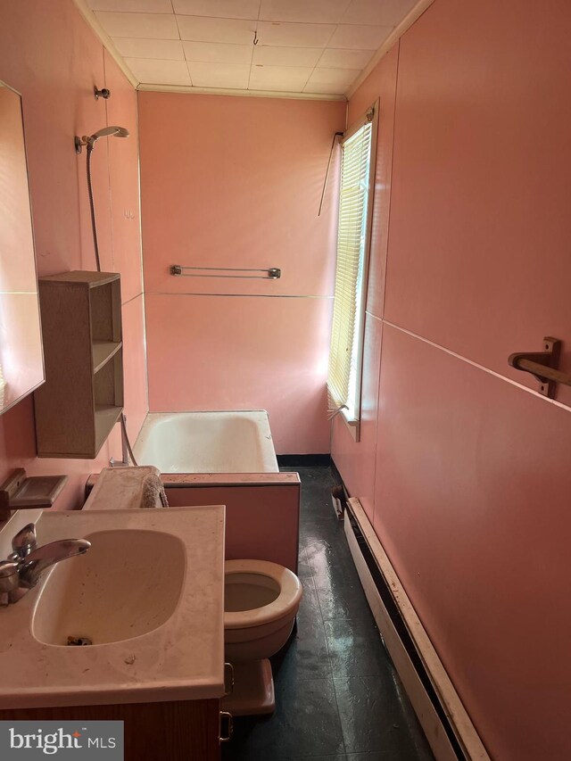 full bathroom with toilet, baseboard heating, vanity, and shower / tub combination