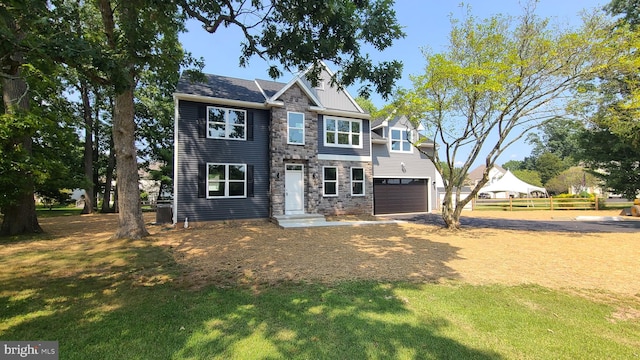 view of front facade featuring a front yard and a garage