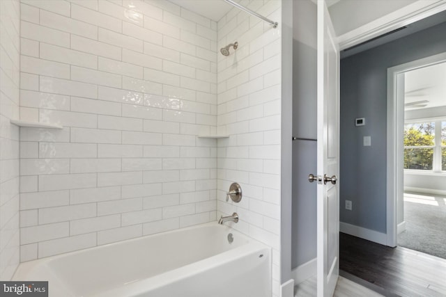 bathroom with tiled shower / bath combo and wood-type flooring