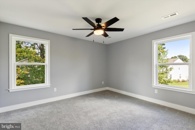 carpeted spare room with ceiling fan