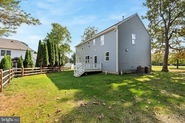 rear view of house featuring a yard and cooling unit