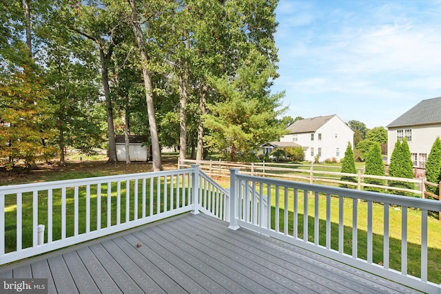 wooden deck featuring a yard