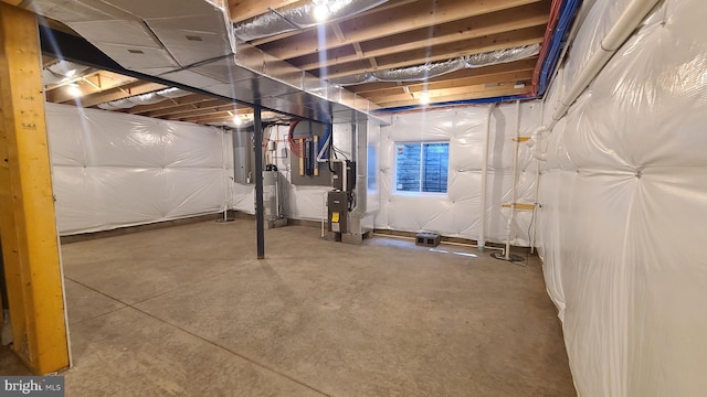 basement featuring gas water heater and heating unit