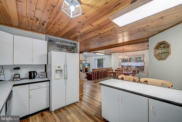 kitchen with light hardwood / wood-style flooring, decorative light fixtures, white cabinets, white refrigerator with ice dispenser, and wooden ceiling