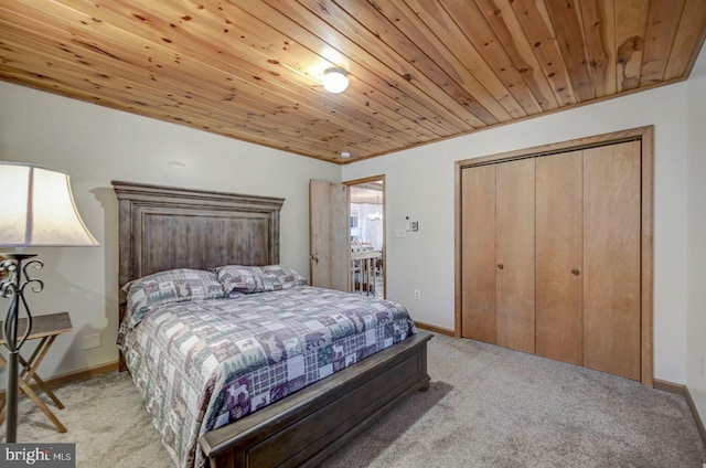 carpeted bedroom with a closet and wooden ceiling