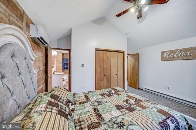 bedroom with ensuite bath, a closet, an AC wall unit, carpet floors, and ceiling fan