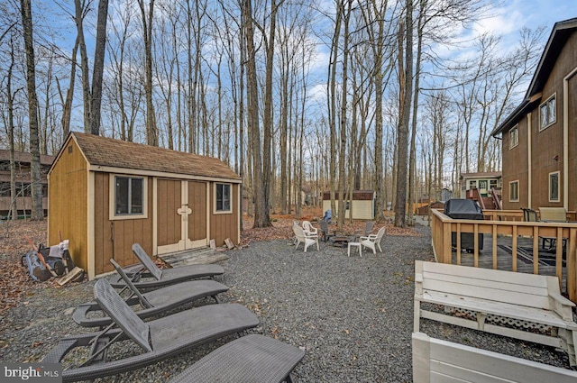 view of yard featuring a shed and a deck