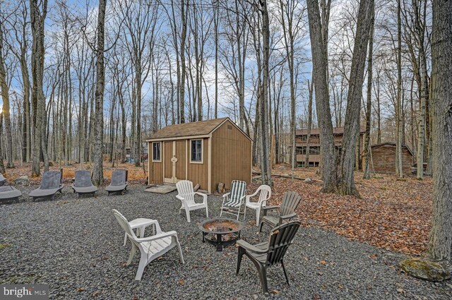 view of yard with a fire pit and a storage unit