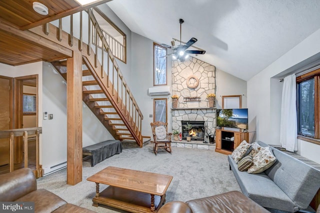 living room with ceiling fan, a fireplace, carpet floors, and a baseboard heating unit