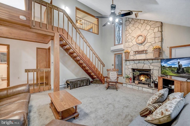 living room with high vaulted ceiling, a stone fireplace, and carpet flooring