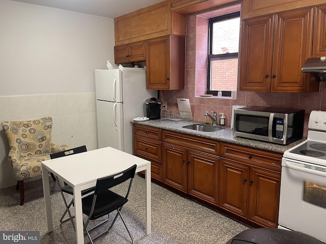 kitchen featuring light tile patterned flooring, sink, and white appliances