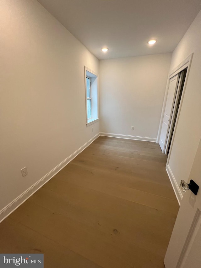 spare room with hardwood / wood-style floors