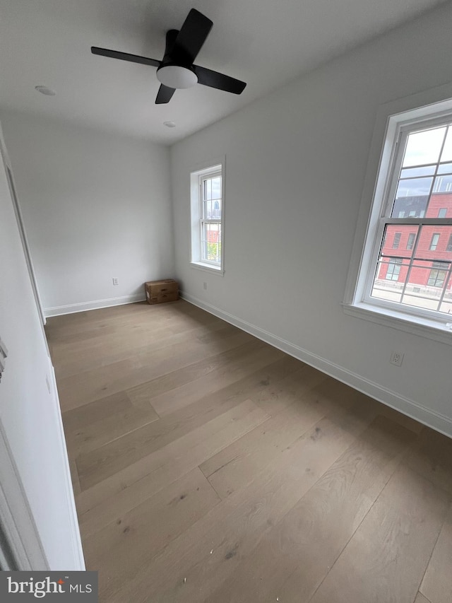 spare room with light hardwood / wood-style flooring and ceiling fan