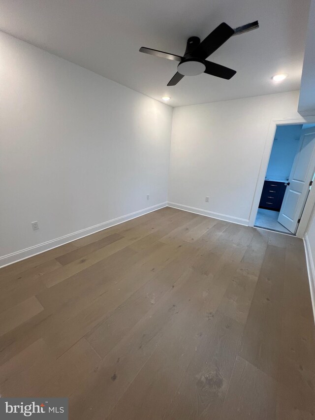 spare room featuring hardwood / wood-style floors and ceiling fan