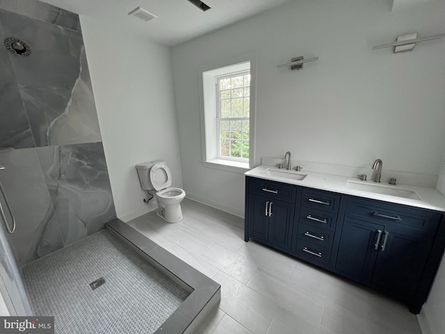 bathroom featuring toilet, walk in shower, vanity, and tile patterned flooring