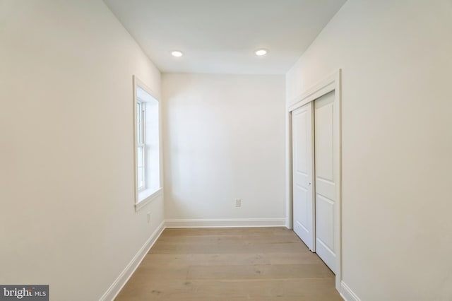 corridor with light wood-type flooring