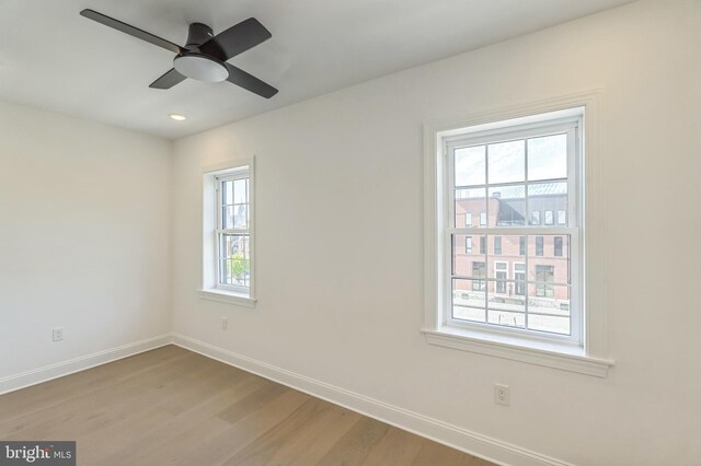 unfurnished room featuring light hardwood / wood-style flooring, a healthy amount of sunlight, and ceiling fan