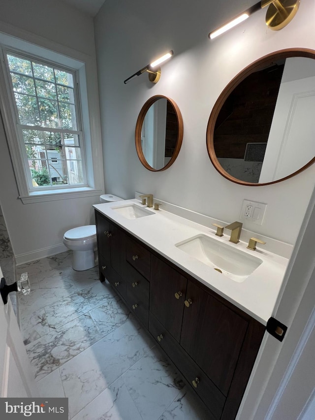 bathroom featuring vanity and toilet