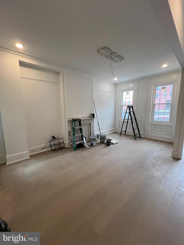 interior space with light hardwood / wood-style floors and crown molding