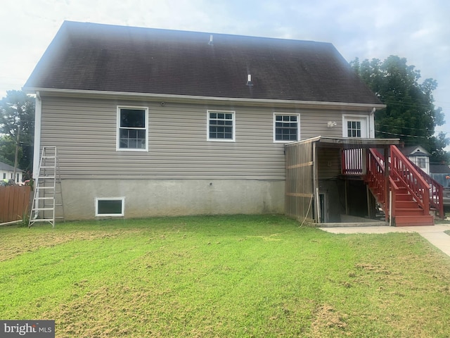 rear view of property featuring a yard