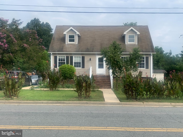 new england style home with a front yard