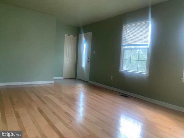 spare room featuring light hardwood / wood-style flooring