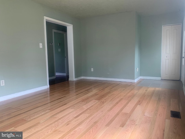 spare room featuring light hardwood / wood-style floors