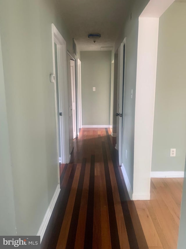 corridor featuring hardwood / wood-style floors