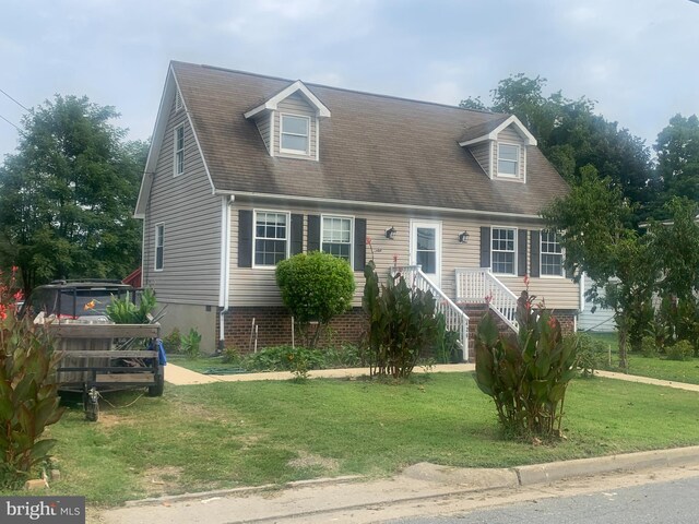 new england style home with a front lawn