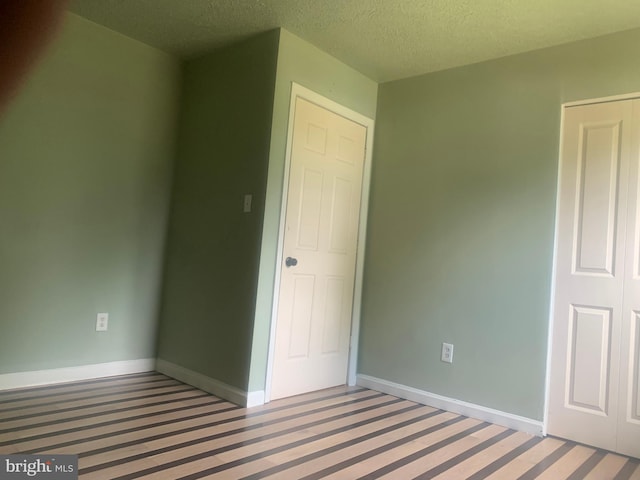 unfurnished bedroom with a textured ceiling