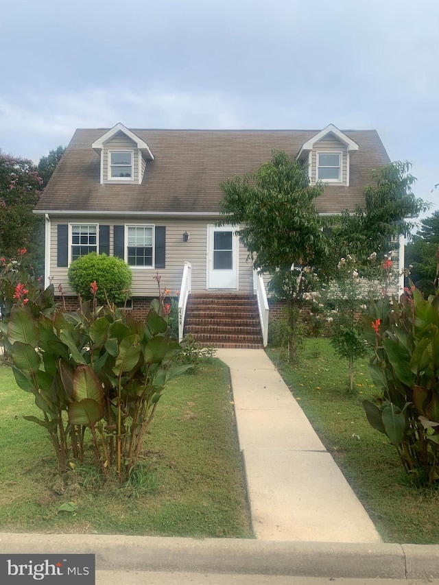 new england style home with a front lawn