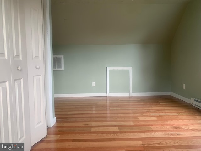 additional living space featuring light hardwood / wood-style floors